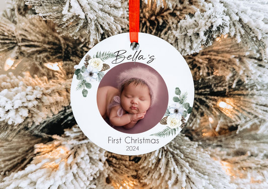 Aluminum Baby's First Christmas Photo Ornament with red ribbon. Includes gift box for easy gift giving. Perfect for new parents and grandparents.