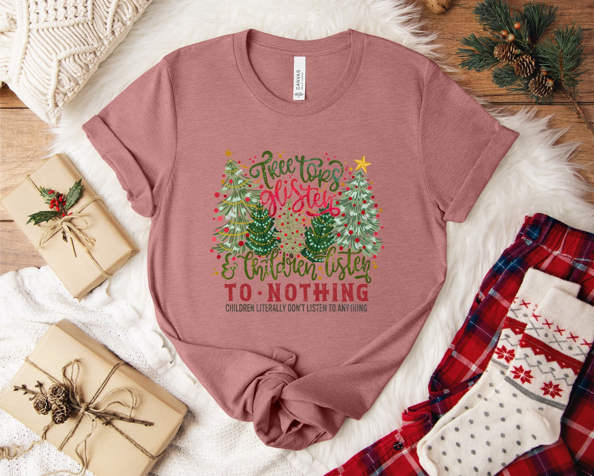 Bella Canvas Christmas T-shirt featuring ‘Tree Tops Glisten and Children Listen To Nothing’ design